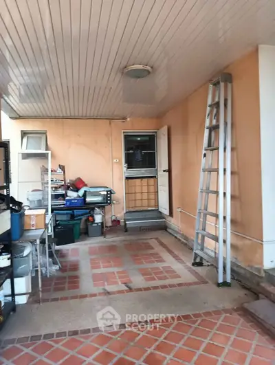 Spacious storage area with ladder and shelving, ideal for organization.