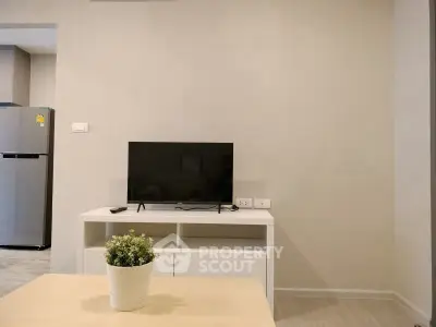 Modern living room with TV and stylish decor in a contemporary apartment.