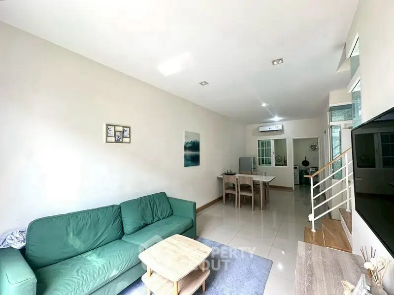 Spacious living room with modern decor and natural light