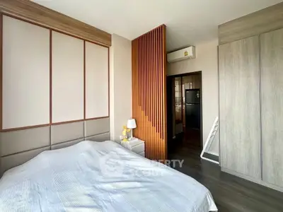Modern bedroom with stylish wooden accents and ample natural light.