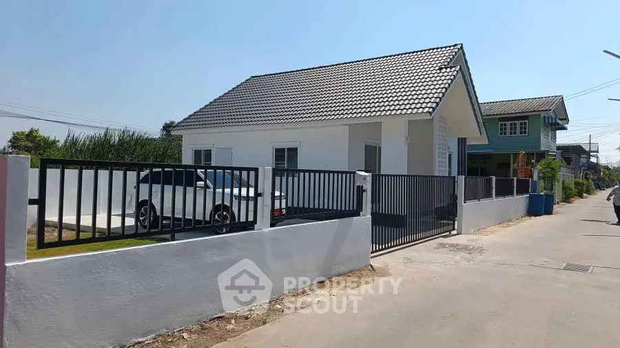 Charming single-story house with modern design and spacious driveway in a serene neighborhood.