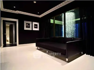 Luxurious modern living room with sleek black decor and elegant lighting