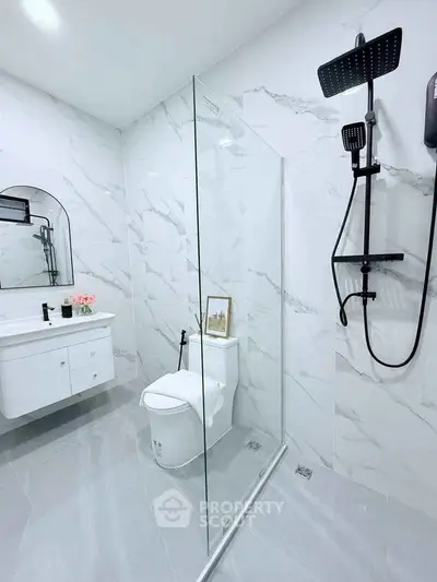 Modern bathroom with sleek shower and elegant vanity in a stylish home.