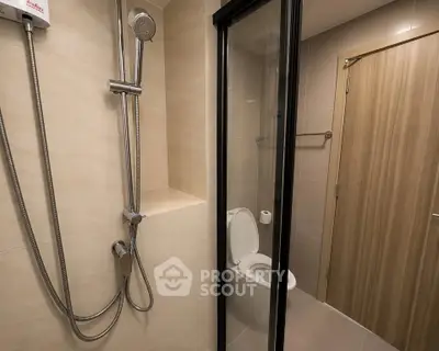 Modern bathroom with glass shower enclosure and sleek fixtures