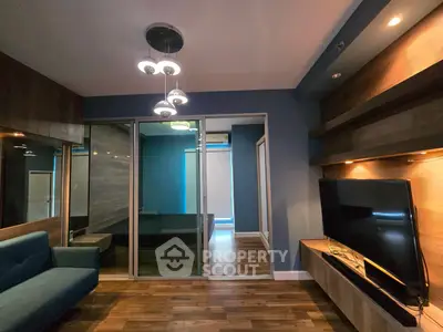 Modern living room with sleek design, wooden flooring, and stylish lighting in a contemporary apartment.