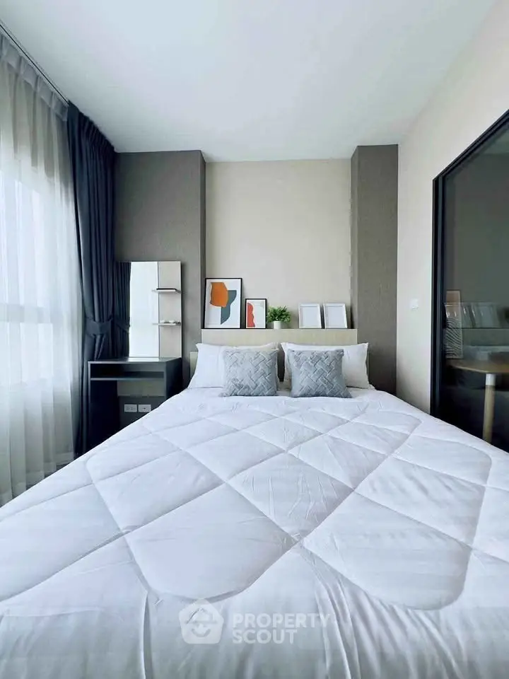 Modern bedroom with stylish decor and large window for natural light