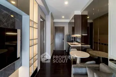 Modern apartment interior with sleek kitchen and cozy living area, featuring elegant finishes and contemporary design.