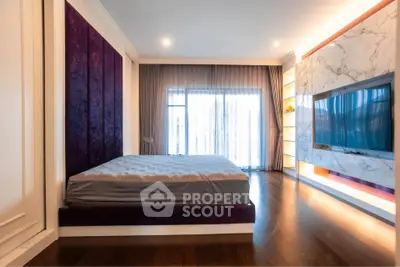 Luxurious bedroom with modern design, featuring a large bed, elegant curtains, and a wall-mounted TV.