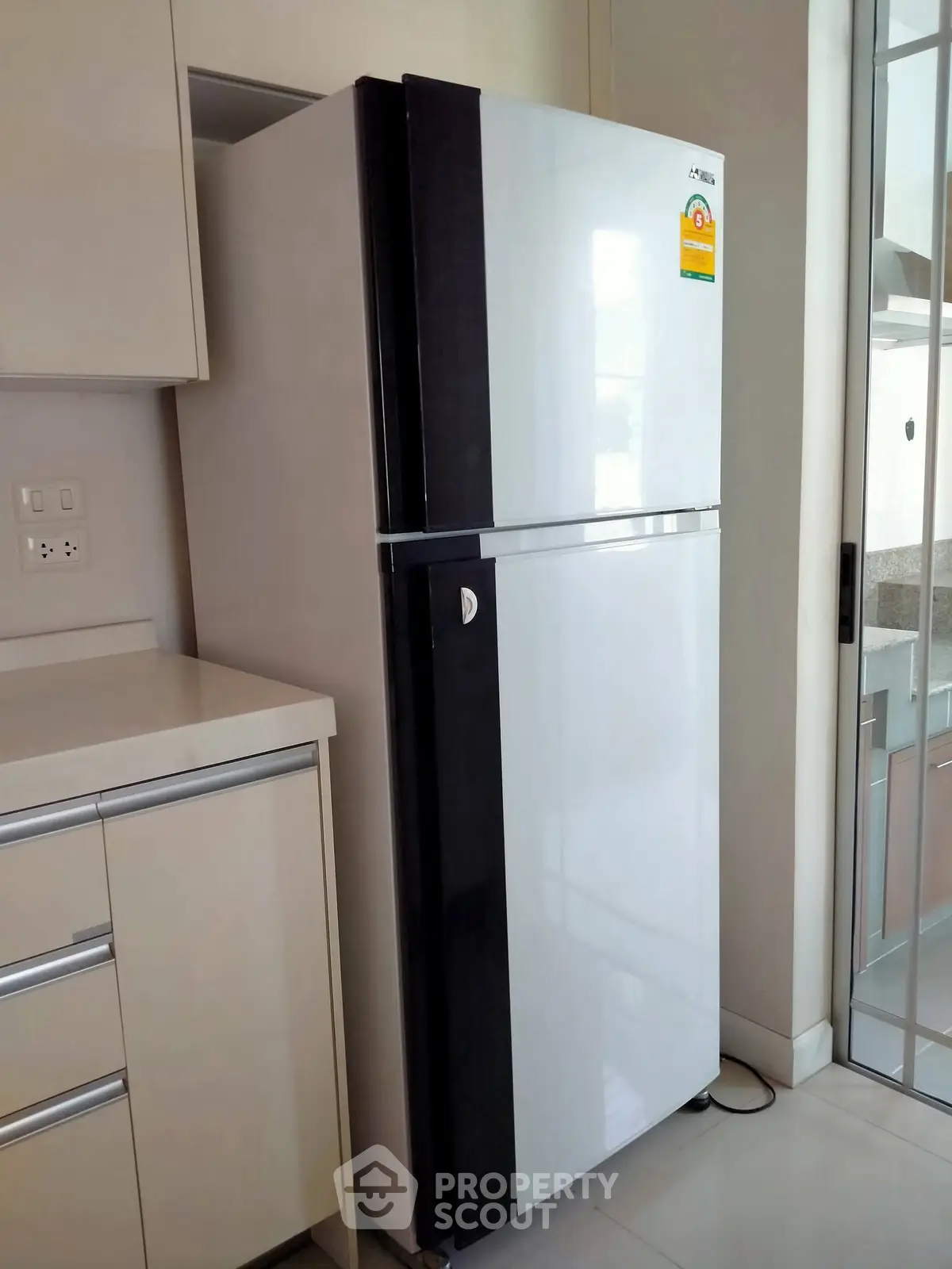 Modern kitchen with sleek refrigerator and stylish cabinetry