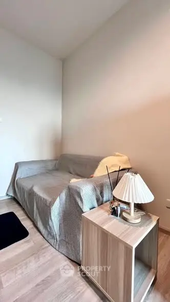 Cozy living room with a comfortable sofa and stylish side table, perfect for relaxation.