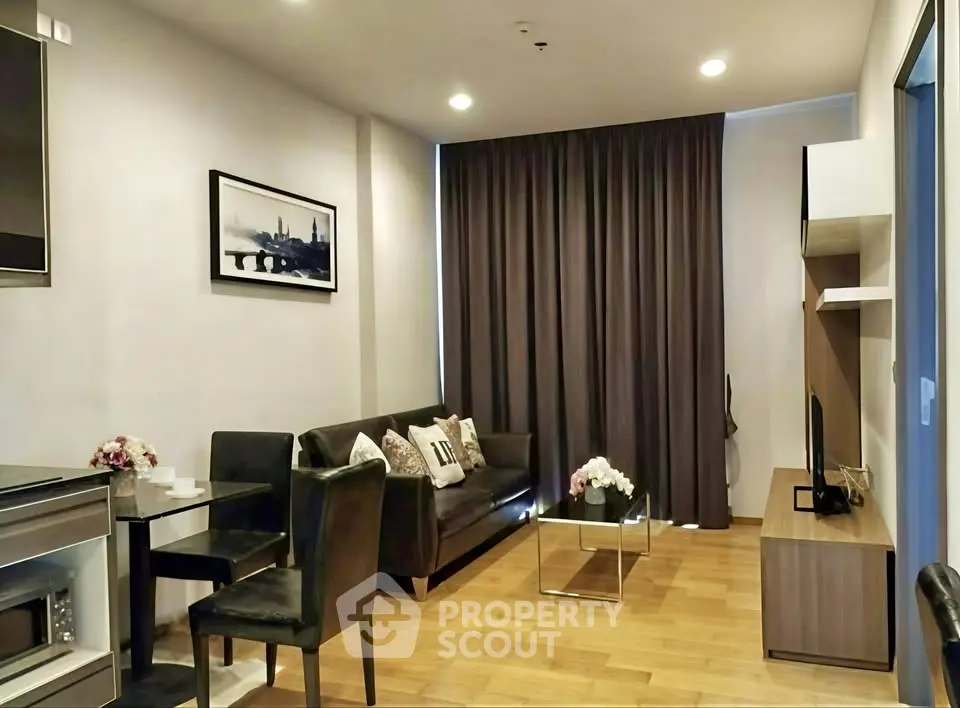 Modern living room with sleek furniture and wooden flooring in a cozy apartment.