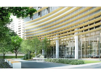 Modern building exterior with glass facade and landscaped garden