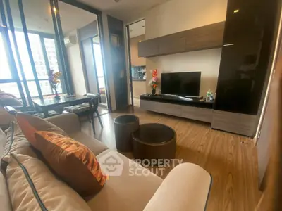 Modern living room with sleek furniture and large windows offering natural light.