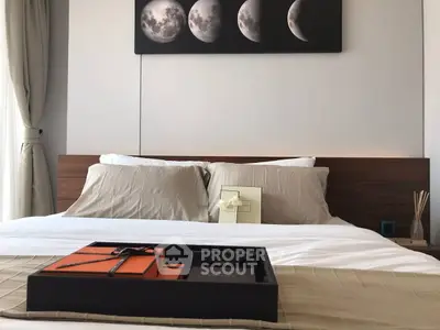 Elegant bedroom with modern decor and moon phase artwork above bed