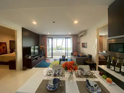 Luxurious open-plan living room with elegant dining area and stunning balcony view.