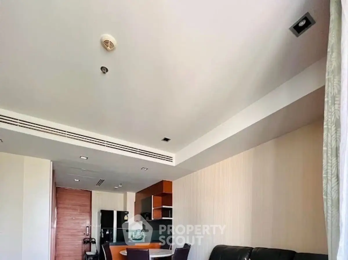 Modern living room with open kitchen layout and stylish furniture