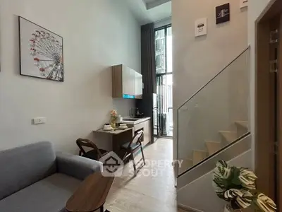 Modern loft apartment with stylish kitchen and cozy living area, featuring high ceilings and natural light.