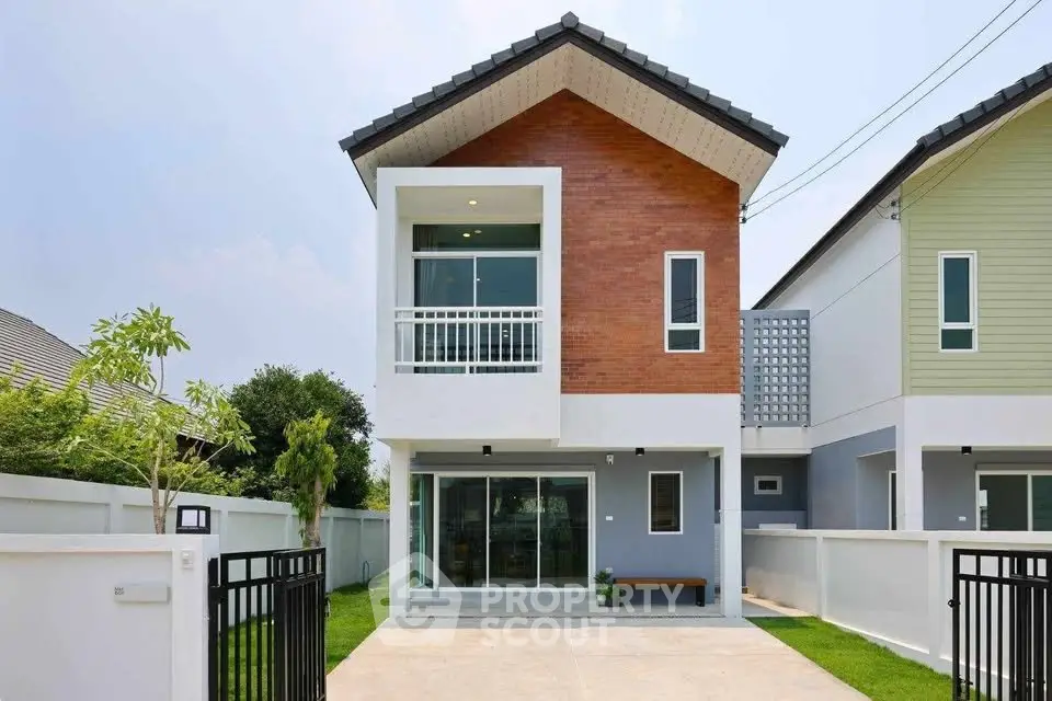 Modern two-story house with a sleek facade and spacious driveway.