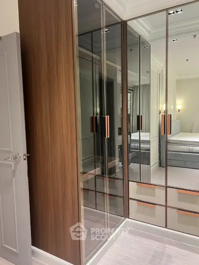 Luxurious bedroom with mirrored wardrobe and elegant lighting