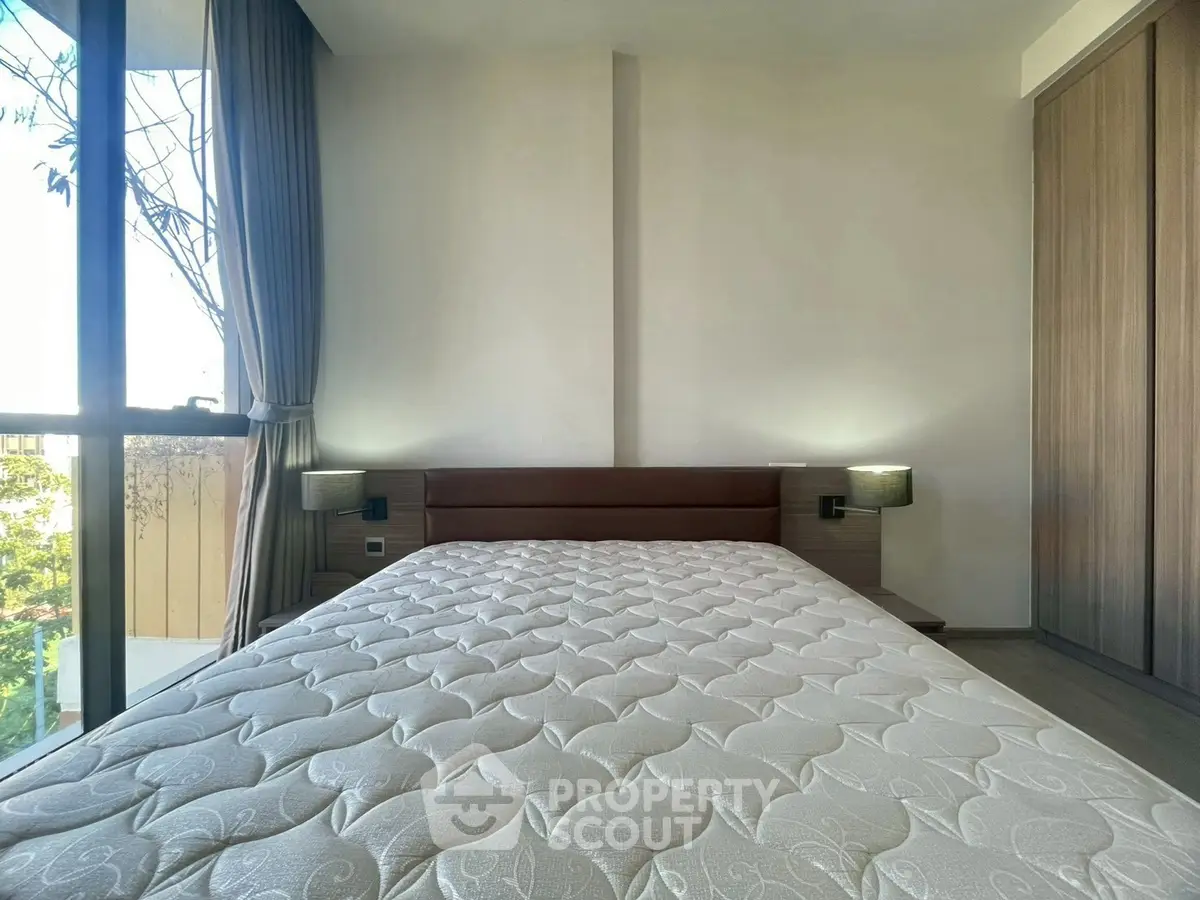 Spacious bedroom with large window and modern design