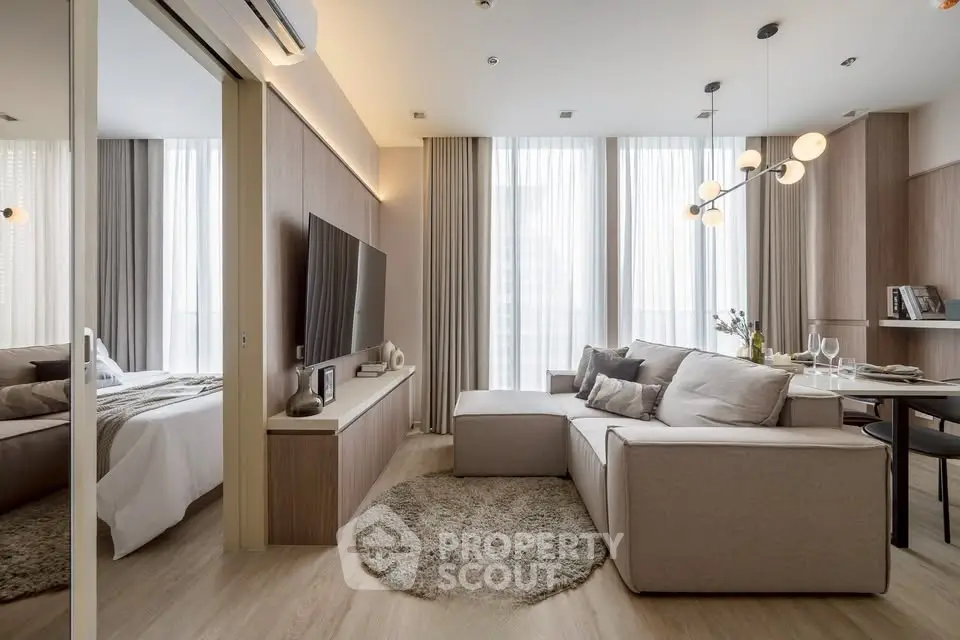 Modern living room with elegant decor and natural light, featuring a cozy sofa and stylish lighting.