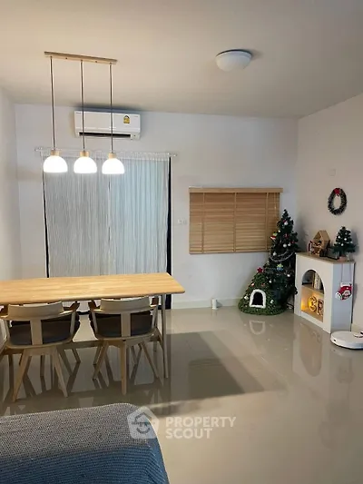 Modern dining area with festive decor and sleek furniture in a cozy apartment.