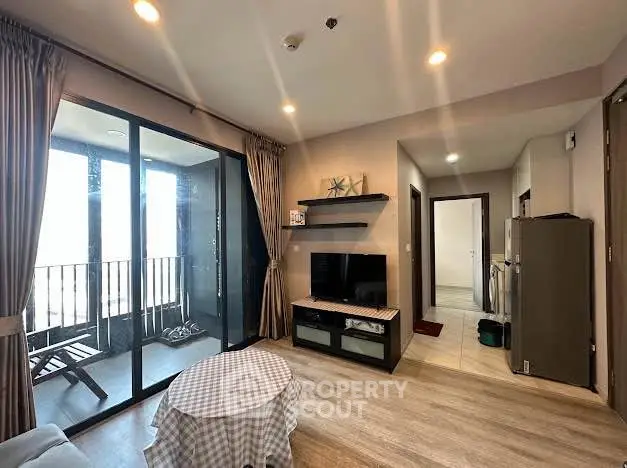Modern living room with balcony access and stylish decor in a cozy apartment.