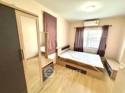 Spacious bedroom with modern wooden furniture and natural light