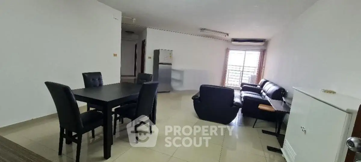 Spacious living room with modern furniture and natural light, perfect for relaxation and entertaining.
