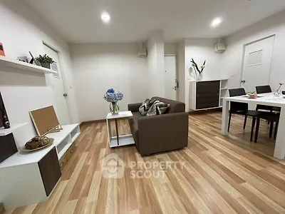 Modern living room with stylish furniture and wooden flooring