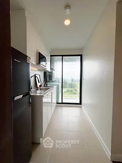 Modern kitchen with sleek appliances and scenic balcony view