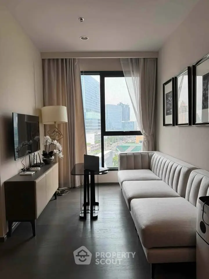 Modern living room with city view, sleek furniture, and elegant decor in a high-rise apartment.