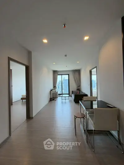 Spacious modern living room with city view and sleek furnishings