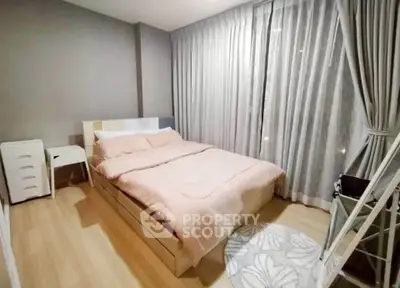 Modern bedroom with cozy decor and large window drapes in a stylish apartment.