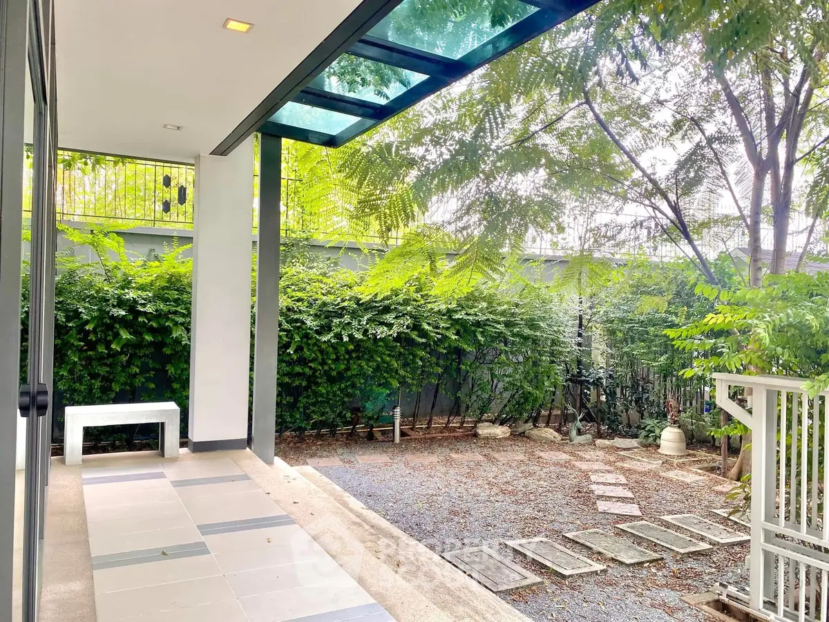 Charming garden view from a modern patio with lush greenery and stylish design.