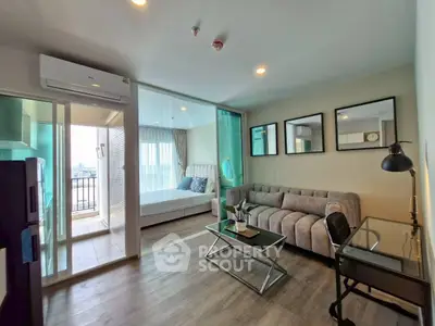 Modern living room with glass partition, cozy sofa, and stylish decor in a high-rise apartment.