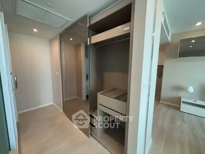 Spacious modern bedroom with built-in wardrobe and elegant lighting
