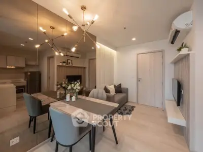 Modern living room with elegant dining area and stylish lighting in a cozy apartment.