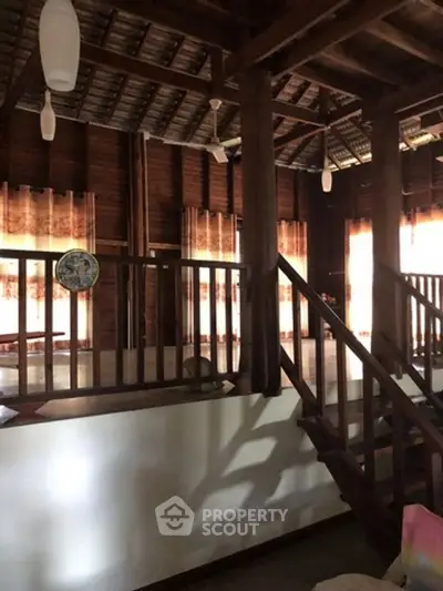 Charming rustic interior with wooden beams and natural light, perfect for cozy living.