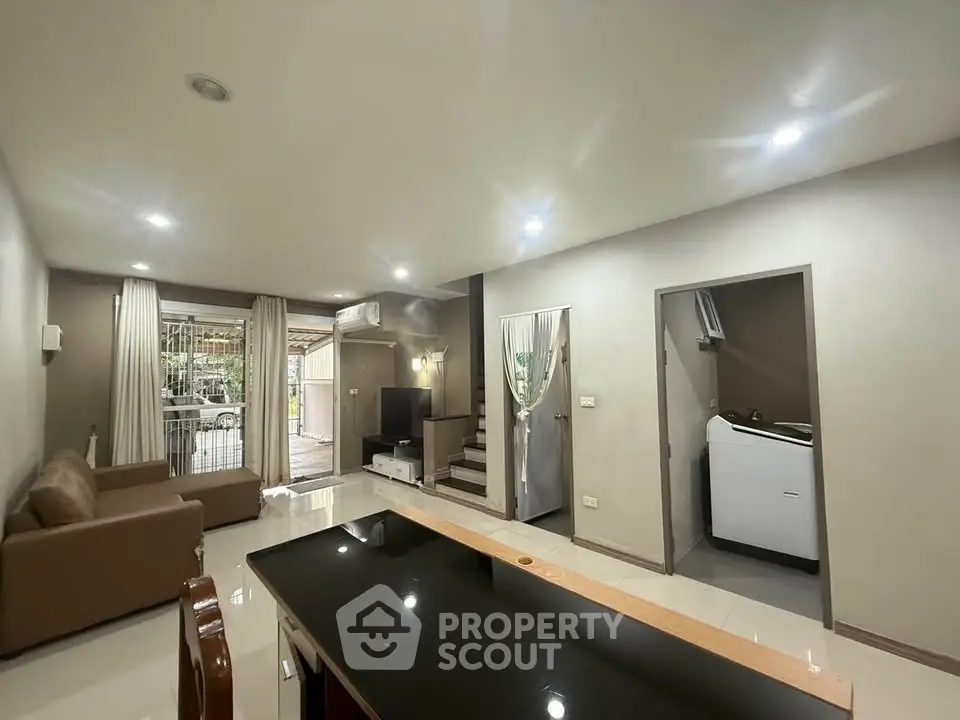 Spacious living room with modern furniture and open layout, perfect for family gatherings.