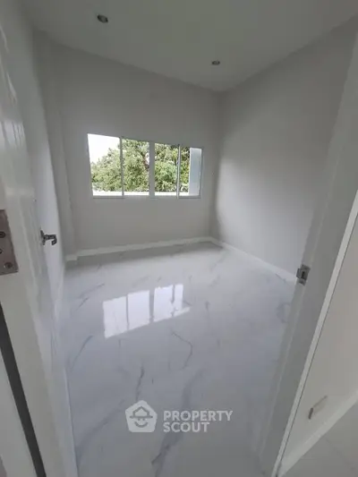 Bright empty room with large window and glossy white marble floor