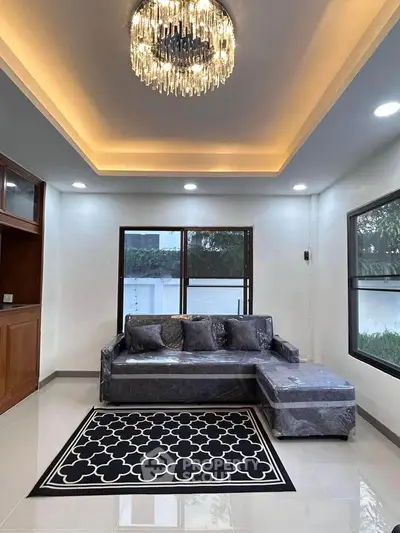 Elegant living room with modern chandelier and stylish sectional sofa