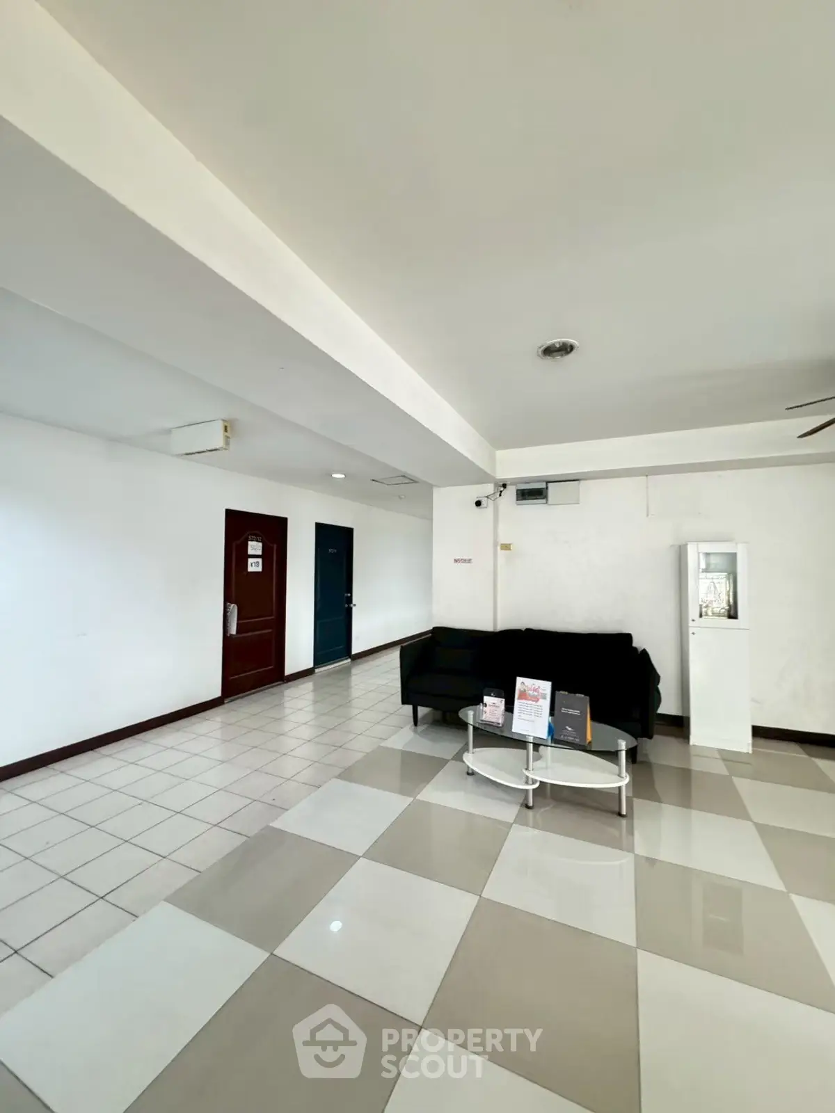 Spacious modern lobby with tiled flooring and sleek furniture