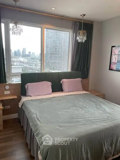 Modern bedroom with city view, featuring elegant lighting and cozy bedding, perfect for urban living.