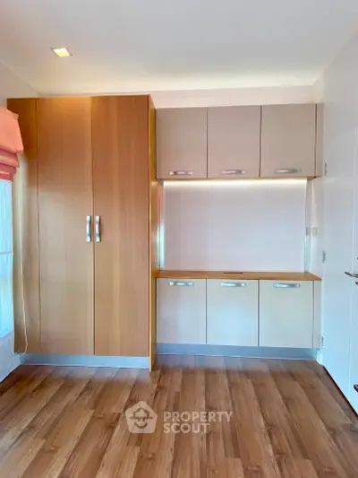 Modern storage area with wooden cabinets and sleek design