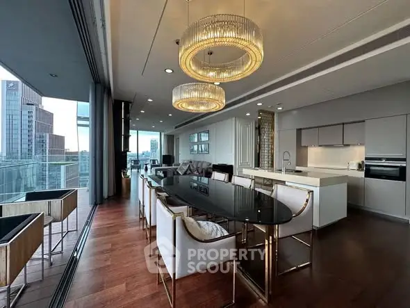 Luxurious open-plan living and dining area with city view and elegant lighting.