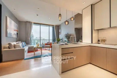 Modern open-plan living room with kitchen, featuring stylish decor and city view.