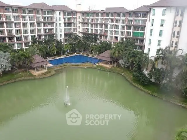 Luxurious apartment complex with serene pond and pool view