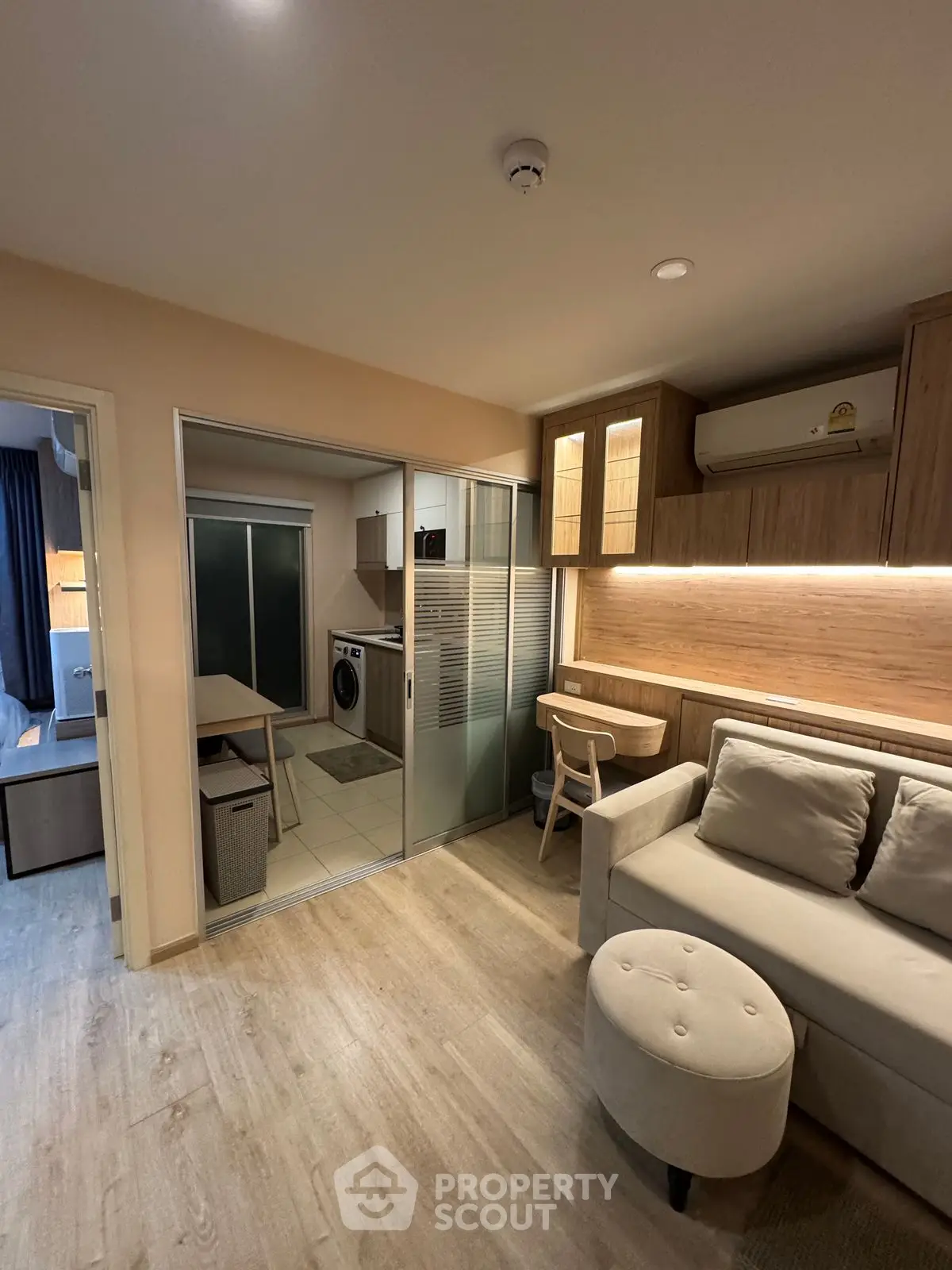 Modern living room with open kitchen and stylish furniture in cozy apartment.