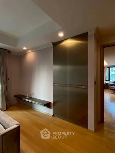 Modern living room with sleek metal cabinet and wooden flooring